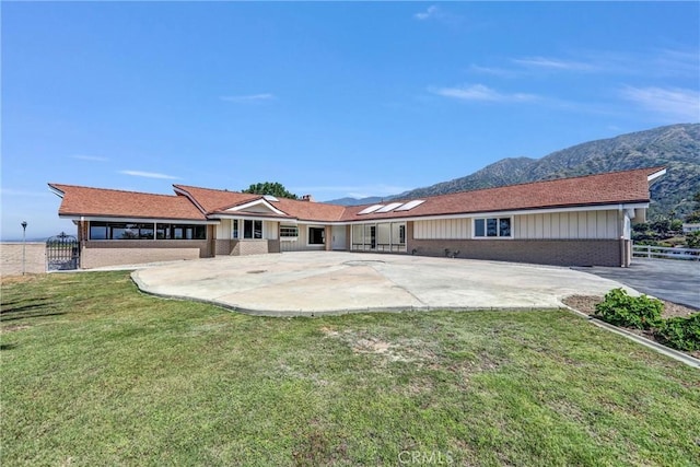 247 El Cielo Ln, Bradbury, CA 91008 - rear view of house with a mountain view, brick siding, a patio, and board and batten siding