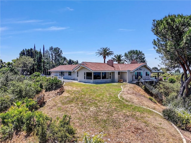 247 El Cielo Ln, Bradbury, CA 91008 - rear view of property featuring a yard, a chimney, and stucco siding