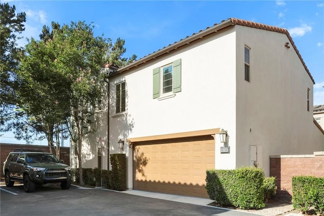 8338 Edgewood St, Chino, CA 91708 - view of side of property featuring stucco siding and a garage