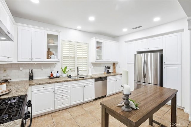 8338 Edgewood St, Chino, CA 91708 - kitchen with stainless steel appliances, backsplash, white cabinets, glass insert cabinets, and light tile patterned floors