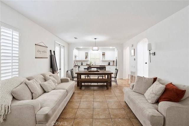8338 Edgewood St, Chino, CA 91708 - living room featuring arched walkways and light tile patterned floors