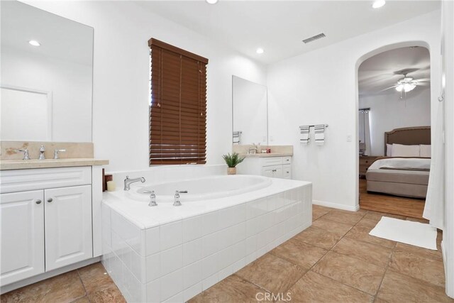 8338 Edgewood St, Chino, CA 91708 - ensuite bathroom featuring two vanities, a bath, a ceiling fan, and recessed lighting