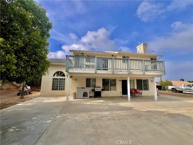 18725 Dallas Ave, Riverside, CA 92508 - rear view of property with a balcony, stucco siding, a patio, and a chimney