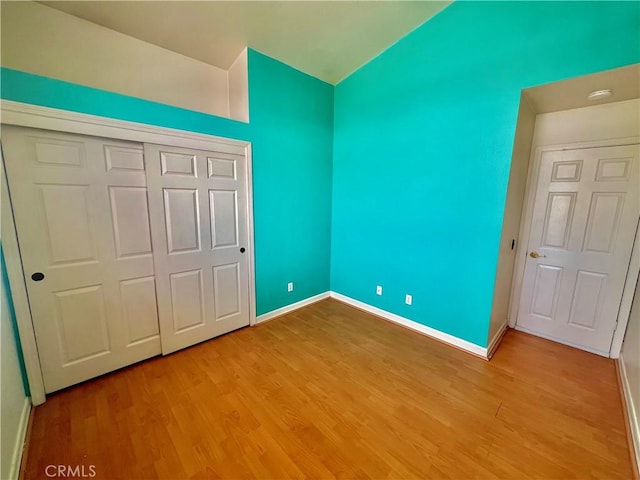 18725 Dallas Ave, Riverside, CA 92508 - unfurnished bedroom featuring lofted ceiling, light wood-style flooring, and a closet