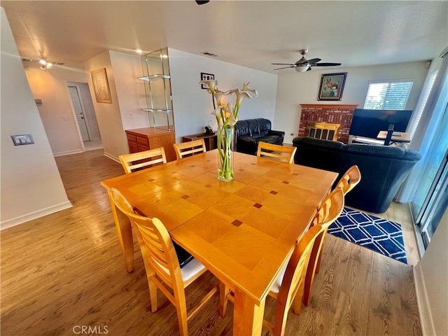 18725 Dallas Ave, Riverside, CA 92508 - dining space with a fireplace, light wood finished floors, and a ceiling fan