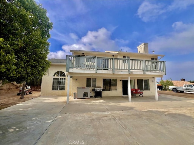 18725 Dallas Ave, Riverside, CA 92508 - rear view of property with a balcony, stucco siding, a patio, and a chimney