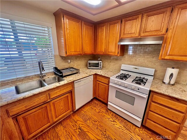 18725 Dallas Ave, Riverside, CA 92508 - kitchen with white appliances, under cabinet range hood, and brown cabinetry