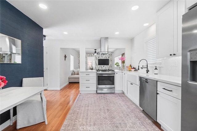 2109 Cathryn Dr, Rosemead, CA 91770 - kitchen featuring stainless steel appliances, island range hood, white cabinetry, light countertops, and recessed lighting