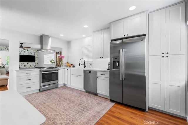 2109 Cathryn Dr, Rosemead, CA 91770 - kitchen with stainless steel appliances, island exhaust hood, light countertops, light wood-type flooring, and white cabinets