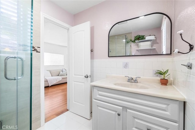 2109 Cathryn Dr, Rosemead, CA 91770 - full bath featuring vanity, a shower stall, tile patterned flooring, tile walls, and wainscoting