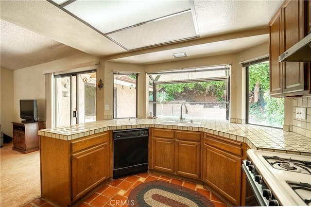3 Bonanza Ct, Pomona, CA 91766 - kitchen with black dishwasher, gas range gas stove, brown cabinetry, a peninsula, and a textured ceiling