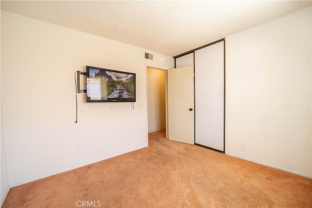 3 Bonanza Ct, Pomona, CA 91766 - unfurnished bedroom with light carpet, a closet, and a textured ceiling