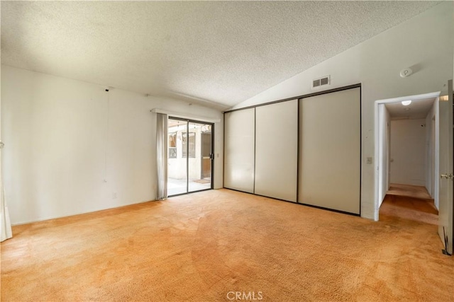 3 Bonanza Ct, Pomona, CA 91766 - unfurnished bedroom featuring a textured ceiling, carpet, vaulted ceiling, a closet, and access to exterior