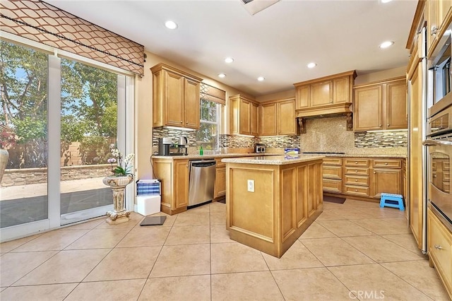 524 S Petunia St, La Habra, CA 90631 - kitchen with appliances with stainless steel finishes, backsplash, a kitchen island, light tile patterned floors, and recessed lighting