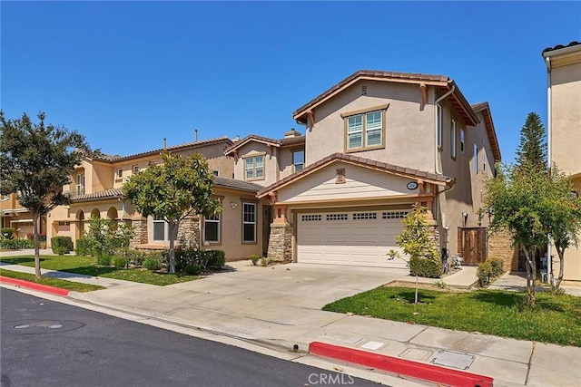 524 S Petunia St, La Habra, CA 90631 - view of front of home with driveway, a garage, stucco siding, and a tile roof