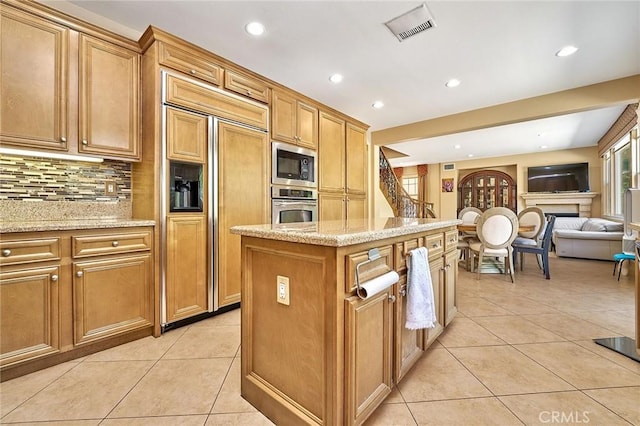 524 S Petunia St, La Habra, CA 90631 - kitchen featuring built in appliances, light tile patterned floors, decorative backsplash, recessed lighting, and a kitchen island