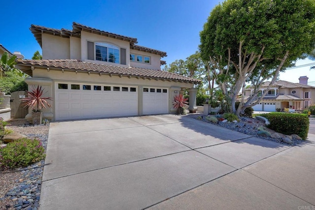 1709 Blackbird Cir, Carlsbad, CA 92011 - mediterranean / spanish house with driveway, a tiled roof, stucco siding, and a garage