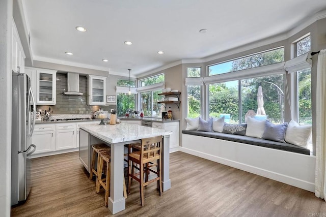1709 Blackbird Cir, Carlsbad, CA 92011 - kitchen with open shelves, wall chimney exhaust hood, stainless steel appliances, decorative backsplash, and white cabinetry