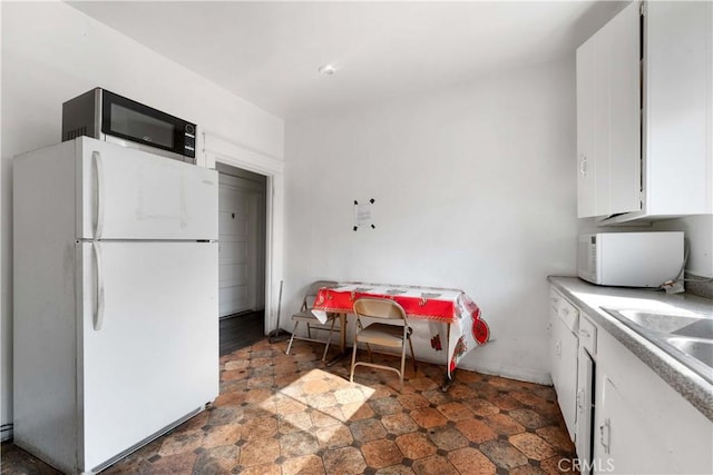 2005 Magnolia Ave, Los Angeles, CA 90007 - kitchen featuring white appliances, white cabinetry, and light countertops