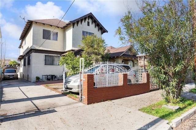 2005 Magnolia Ave, Los Angeles, CA 90007 - view of front of property with stucco siding, driveway, and a fenced front yard