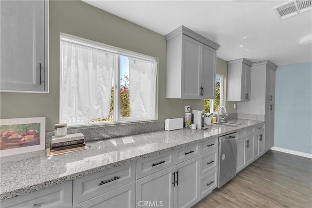 74417 Maricopa Dr Unit 29, Palms, CA 92277 - kitchen featuring dishwasher, light wood finished floors, light stone countertops, and white cabinetry