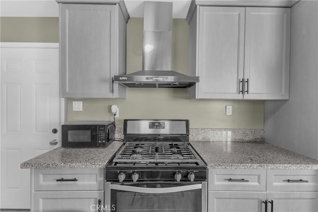 74417 Maricopa Dr Unit 29, Palms, CA 92277 - kitchen featuring stainless steel gas range, wall chimney exhaust hood, black microwave, and light stone countertops