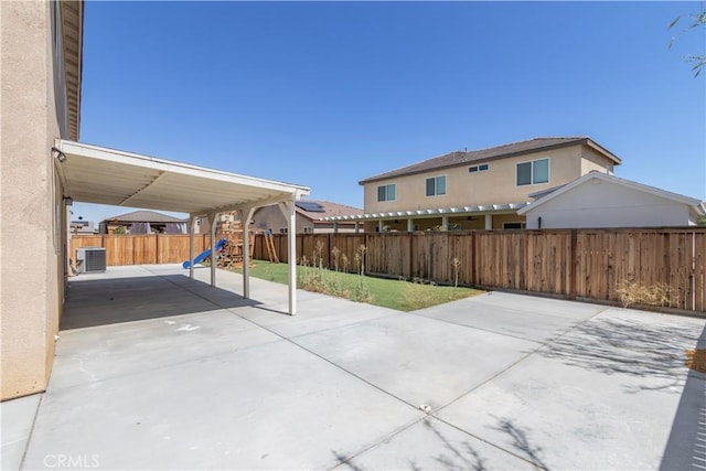 3720 Mount Whitney Ave, Rosamond, CA 93560 - fenced backyard featuring a playground, a patio area, and driveway