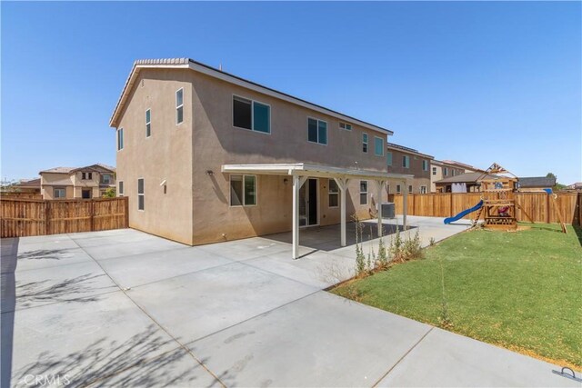 3720 Mount Whitney Ave, Rosamond, CA 93560 - back of property with a patio area, a playground, a fenced backyard, and stucco siding