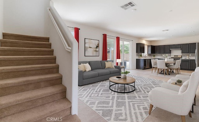 3720 Mount Whitney Ave, Rosamond, CA 93560 - living room with stairway and light carpet