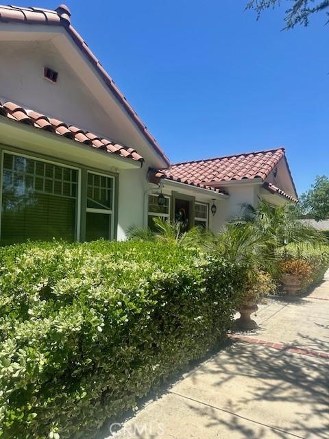 13621 Erwin St, Van Nuys, CA 91401 - view of side of home with a tiled roof and stucco siding
