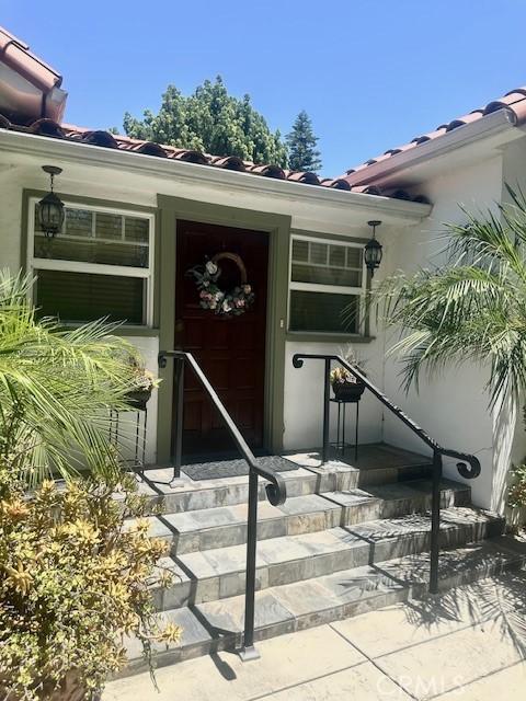 13621 Erwin St, Van Nuys, CA 91401 - property entrance featuring a tile roof and stucco siding