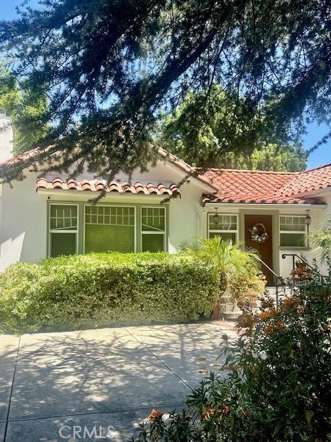 13621 Erwin St, Van Nuys, CA 91401 - mediterranean / spanish house with a tile roof, stucco siding, and a chimney