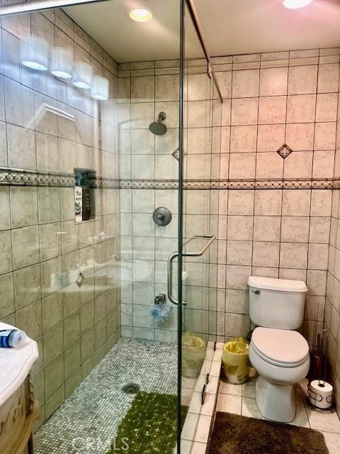 13621 Erwin St, Van Nuys, CA 91401 - full bath featuring tile patterned flooring, a shower stall, and tile walls