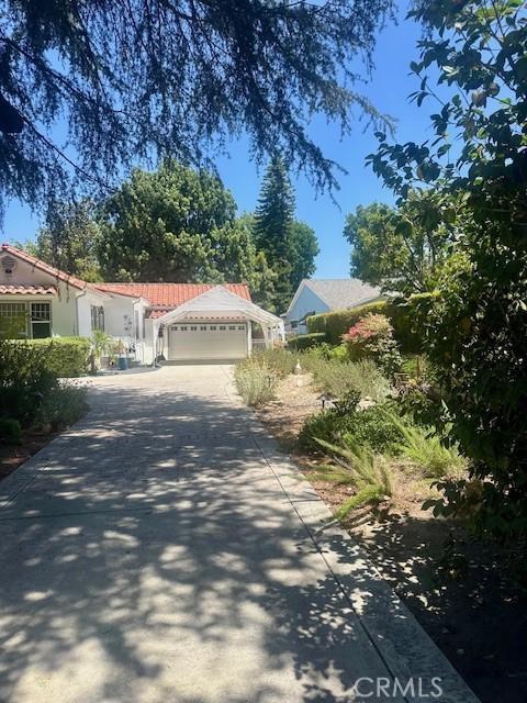 13621 Erwin St, Van Nuys, CA 91401 - view of front facade featuring concrete driveway, a garage, and a tiled roof