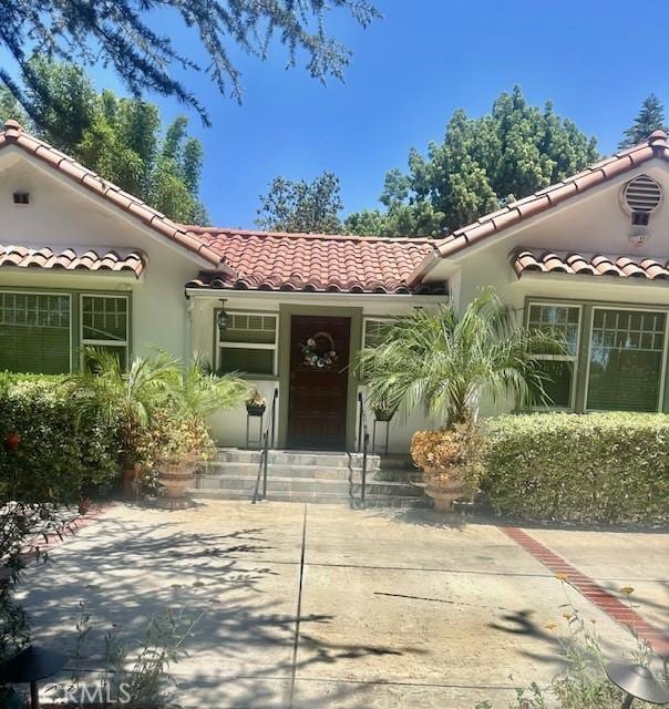 13621 Erwin St, Van Nuys, CA 91401 - property entrance featuring a tiled roof and stucco siding