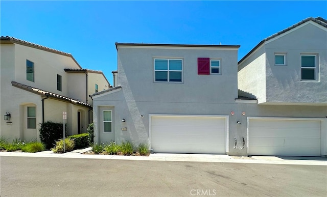 4173 Horvath St Unit 104, Corona, CA 92883 - view of front facade featuring stucco siding and an attached garage