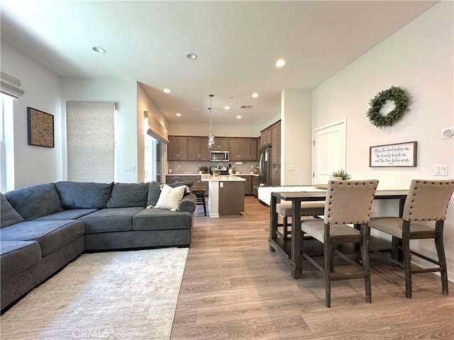 4173 Horvath St Unit 104, Corona, CA 92883 - living room with light wood-style floors and recessed lighting