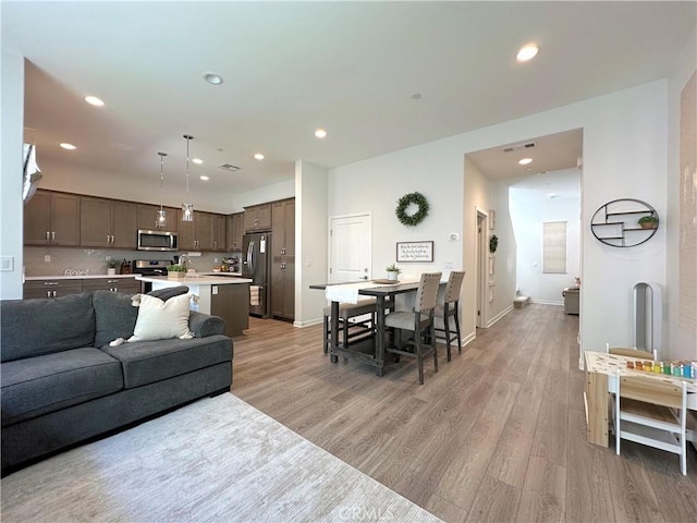 4173 Horvath St Unit 104, Corona, CA 92883 - living room with light wood-style floors and recessed lighting