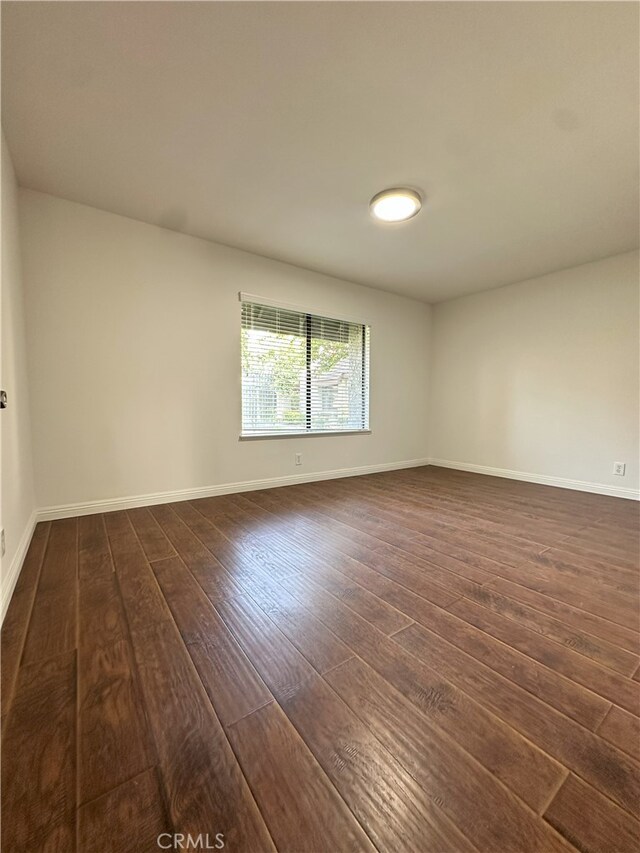 16144 Crystal Creek Ln, Cerritos, CA 90703 - spare room with dark wood-type flooring and baseboards