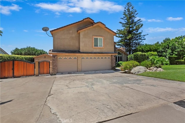 8247 Jennet St, Rancho Cucamonga, CA 91701 - view of front of property featuring concrete driveway, stucco siding, a gate, and a garage