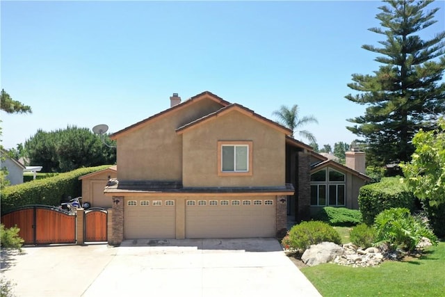 8247 Jennet St, Rancho Cucamonga, CA 91701 - view of front of property featuring an attached garage, concrete driveway, a gate, stucco siding, and a chimney