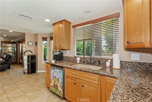 8247 Jennet St, Rancho Cucamonga, CA 91701 - kitchen with dishwasher, dark stone countertops, light tile patterned floors, and recessed lighting
