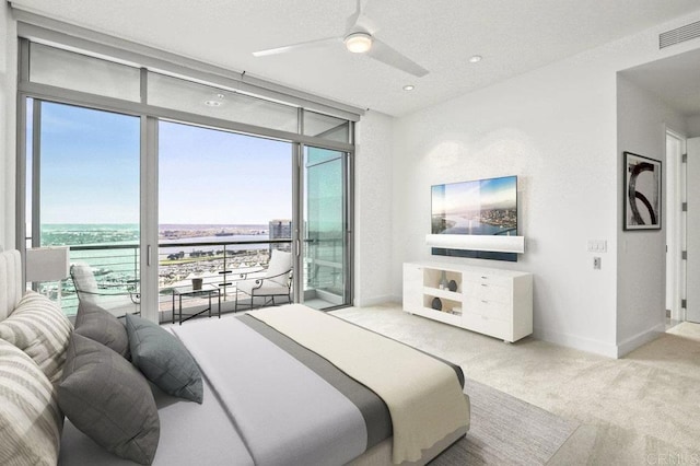 165 6th Ave Unit 2504, San Diego, CA 92101 - bedroom featuring a wall of windows, access to outside, carpet floors, a water view, and ceiling fan