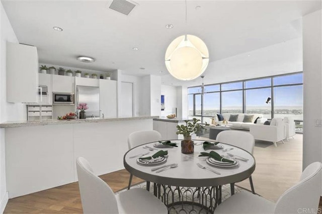 165 6th Ave Unit 2504, San Diego, CA 92101 - dining room featuring wood finished floors