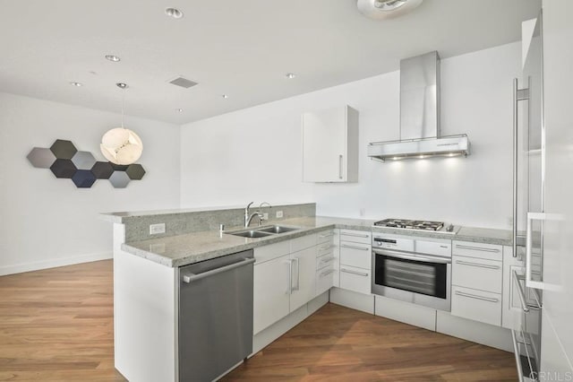 165 6th Ave Unit 2504, San Diego, CA 92101 - kitchen with stainless steel appliances, wall chimney exhaust hood, a peninsula, light countertops, and white cabinets
