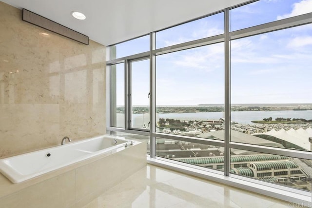 165 6th Ave Unit 2504, San Diego, CA 92101 - bathroom featuring a water view, healthy amount of natural light, a bath, tile patterned floors, and floor to ceiling windows