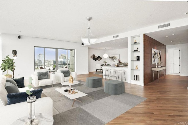 165 6th Ave Unit 2504, San Diego, CA 92101 - living room featuring wood finished floors and built in shelves