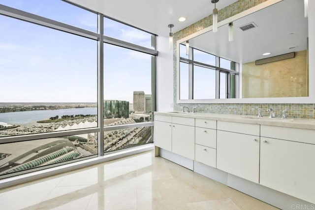 165 6th Ave Unit 2504, San Diego, CA 92101 - full bathroom with double vanity, tile patterned floors, backsplash, and a water view