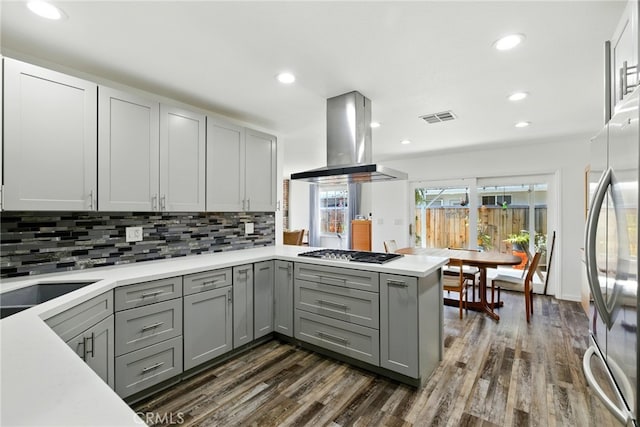 3101 Maple Ave, Fullerton, CA 92835 - kitchen featuring gray cabinets, ventilation hood, appliances with stainless steel finishes, dark wood-style flooring, and decorative backsplash