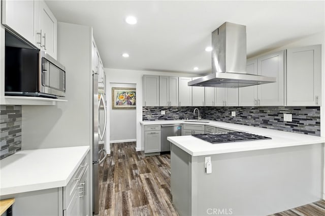 3101 Maple Ave, Fullerton, CA 92835 - kitchen with island exhaust hood, stainless steel appliances, a peninsula, dark wood-style floors, and backsplash